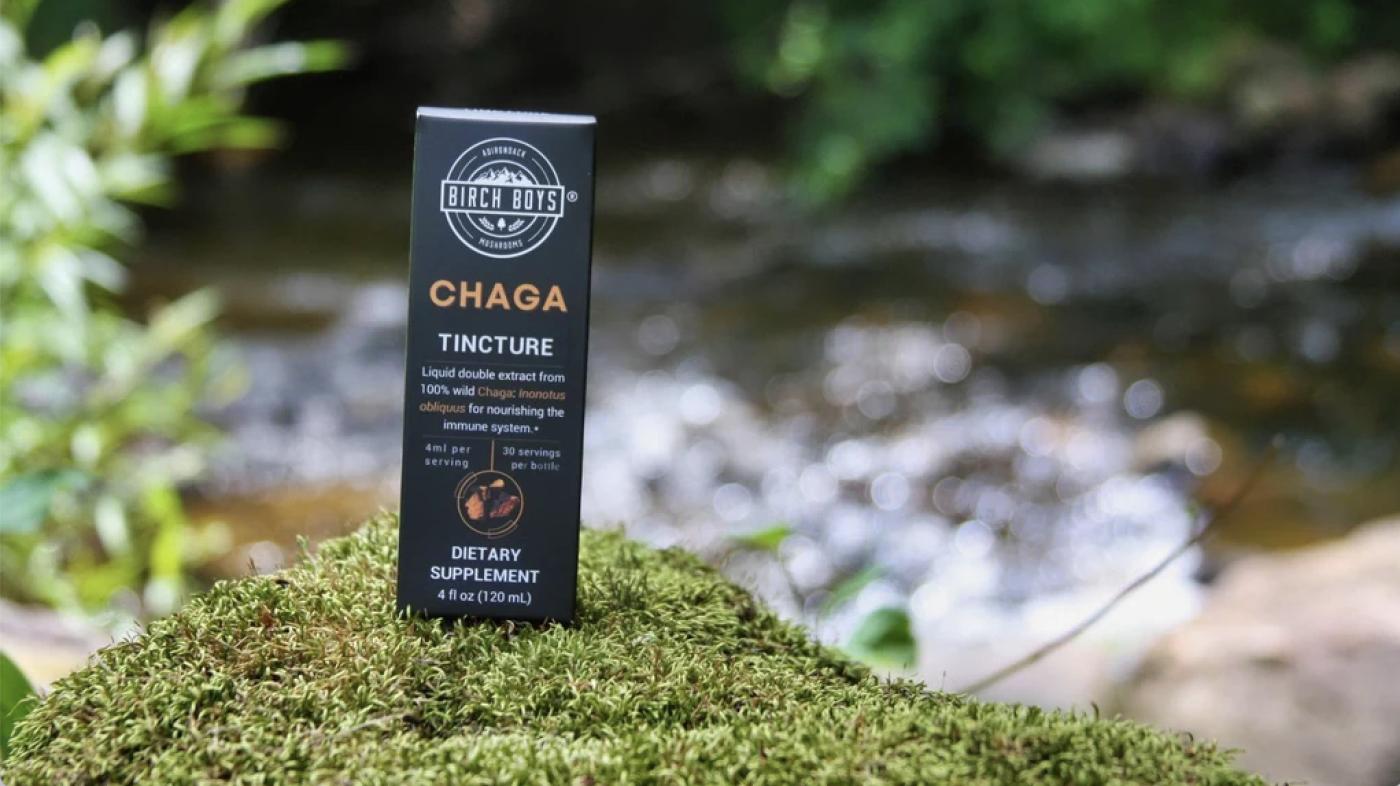 Birch Boys chaga tincture packaging with a river in the background.