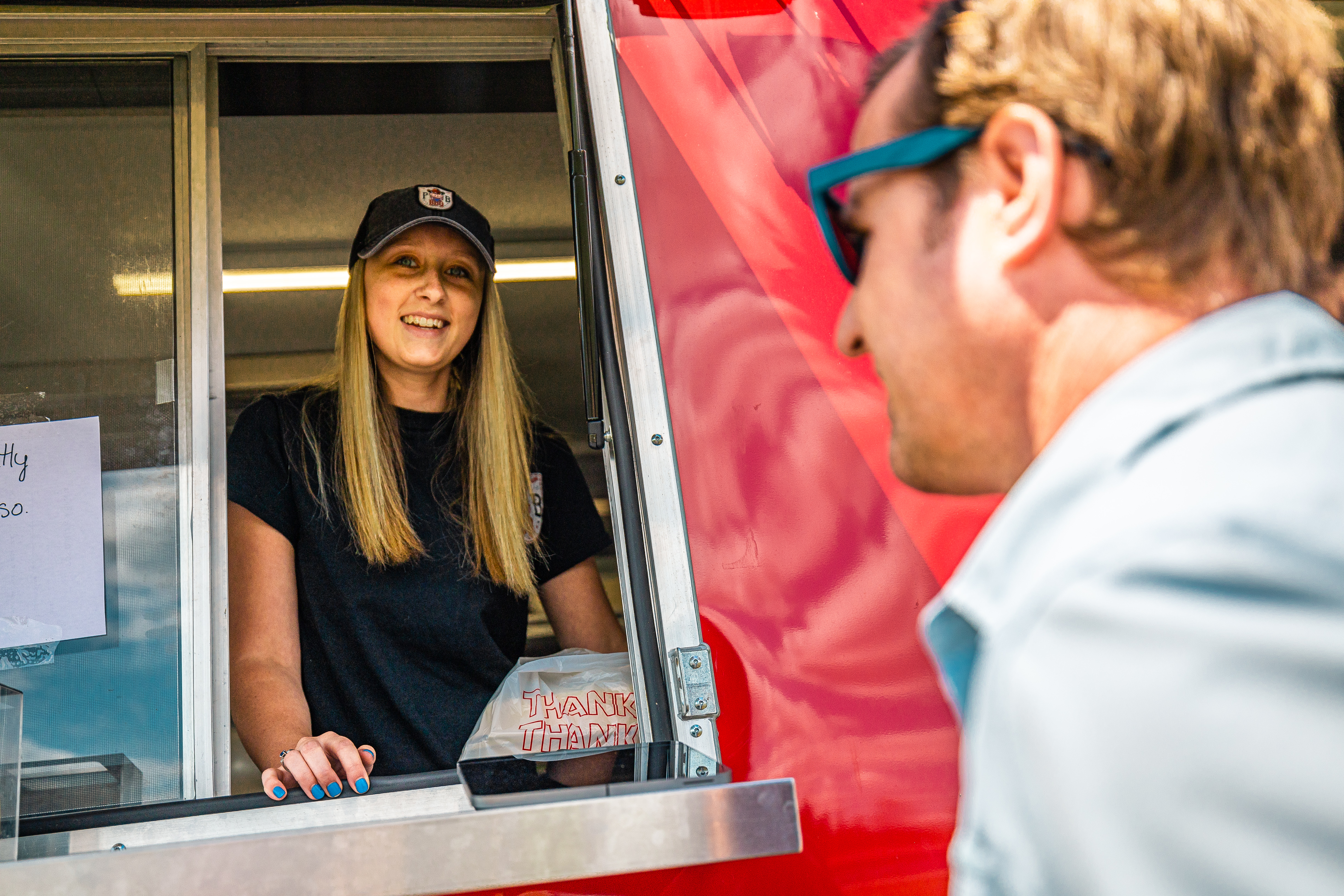Customer visiting a food truck in Tupper Lake, employed by a student