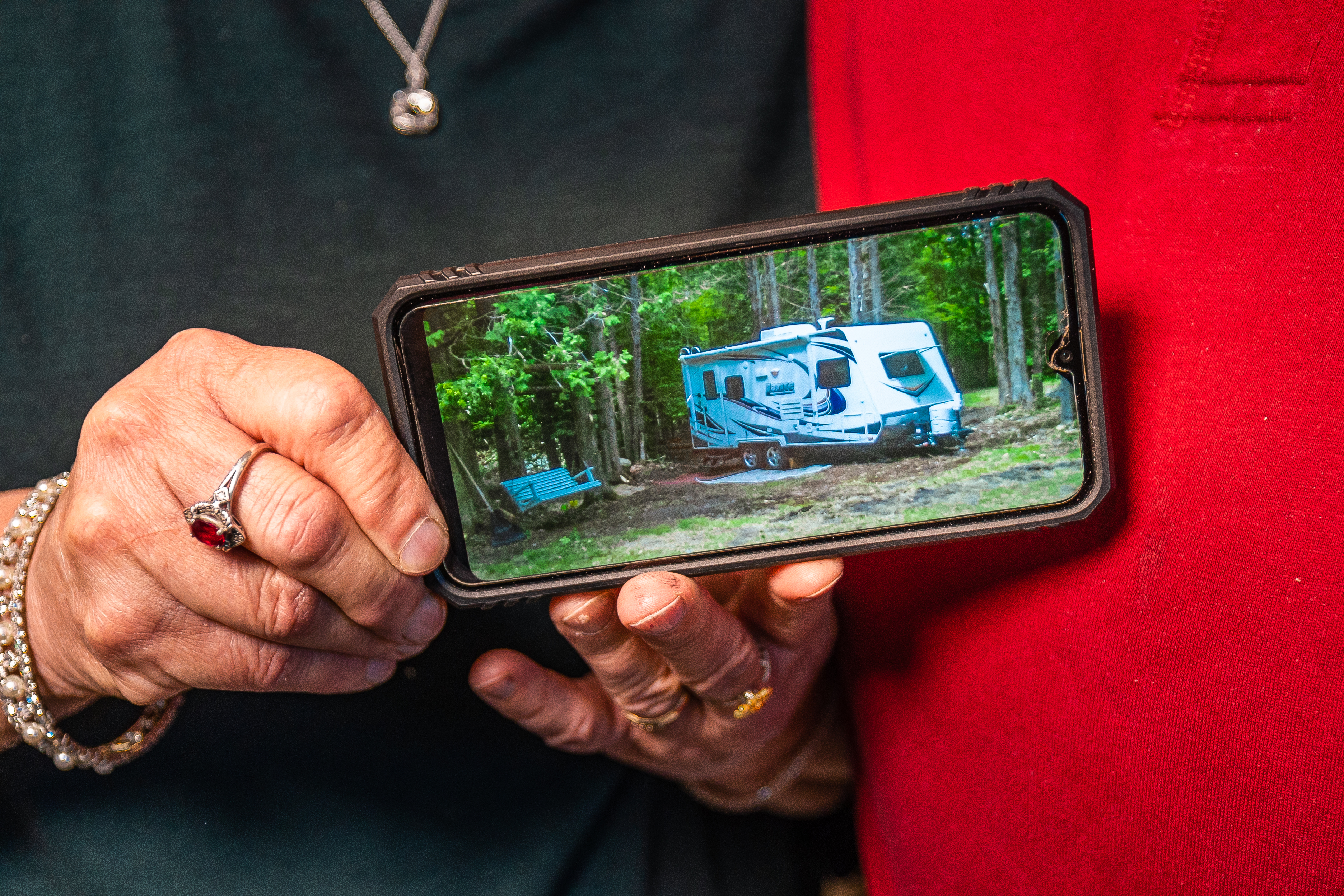 member holding up a photo of their camper they got through a loan at Adirondack Regional Federal Credit Union