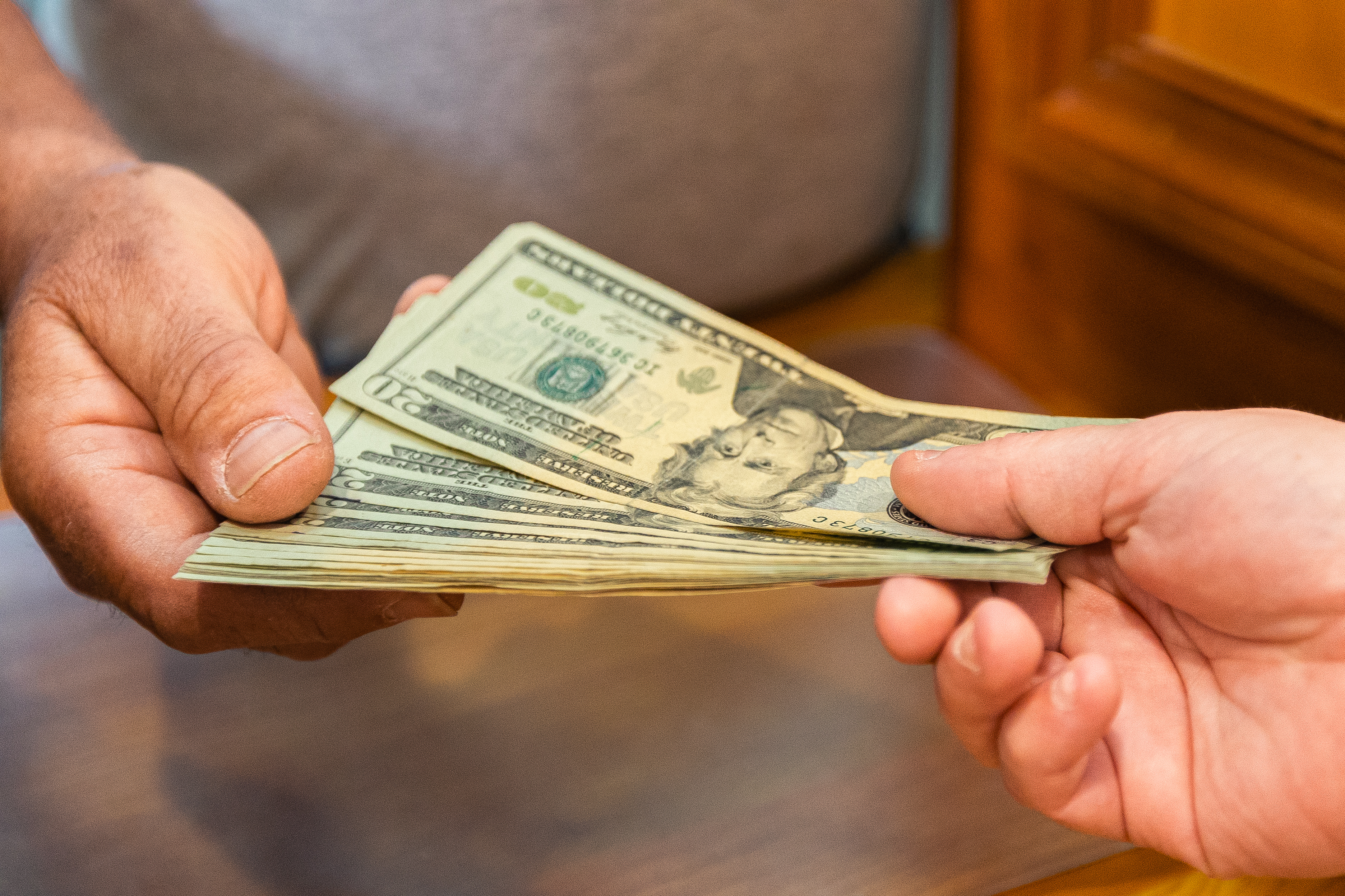 teller at a credit union handing money to a member