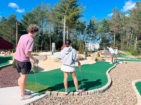 Golfers on the green at Timberjaxx Pass