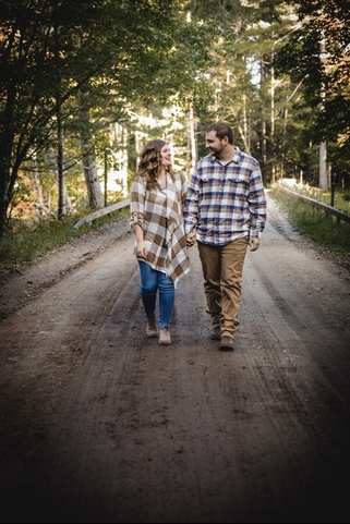 Alivia walking on a gravel road with her partner.