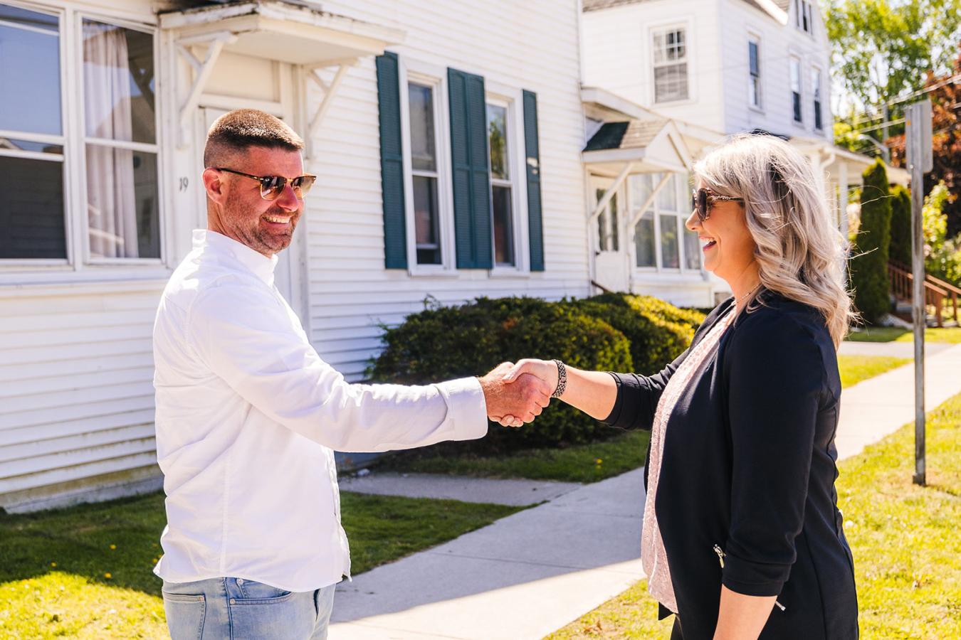 local Plattsburgh man shaking hands with his realtor after getting a mortgage through the Plattsburgh credit union branch