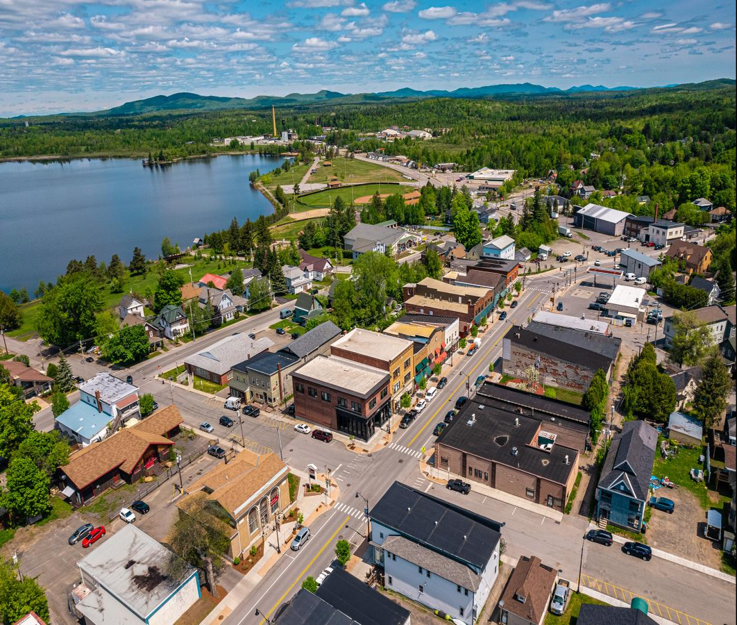 aerial view of tupper lake with the OWD factory tower in the distance