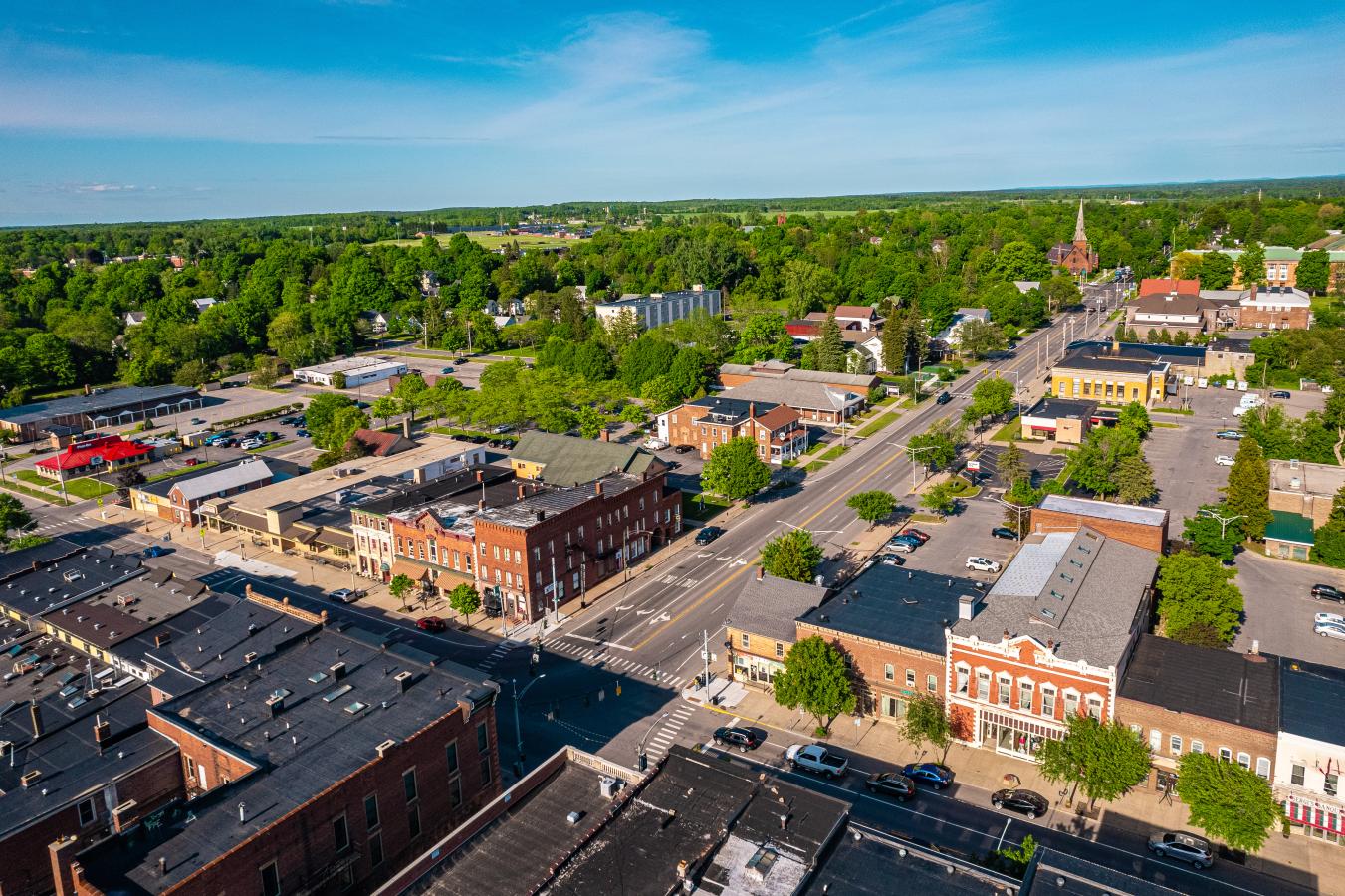 Arial view of Potsdam, NY. Brick buildings and trees line the streets.