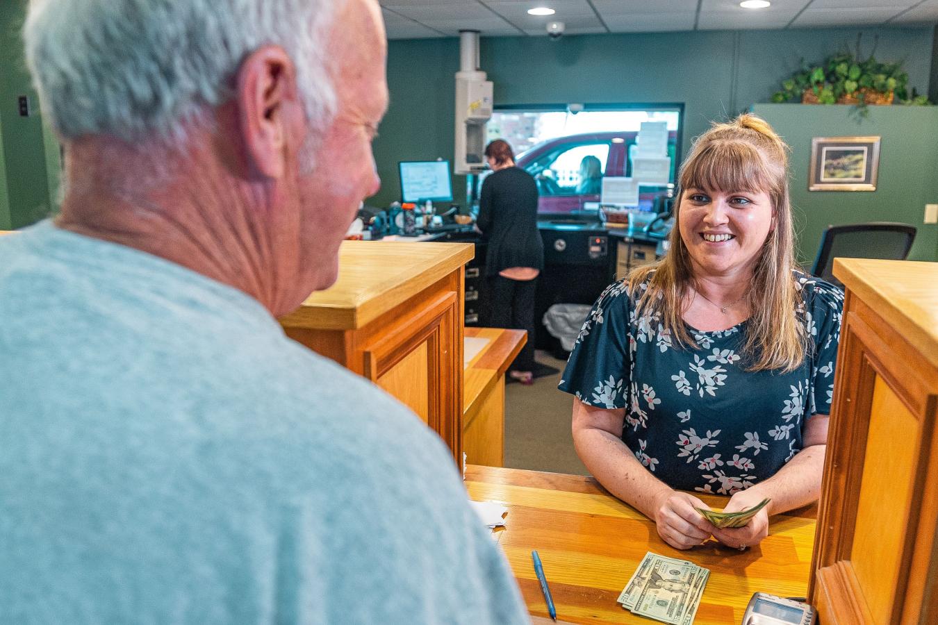 Credit Union teller interacting with customer.