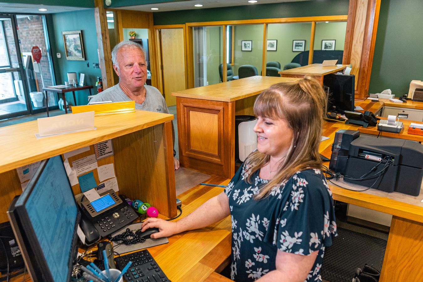A bank teller assisting a customer. 