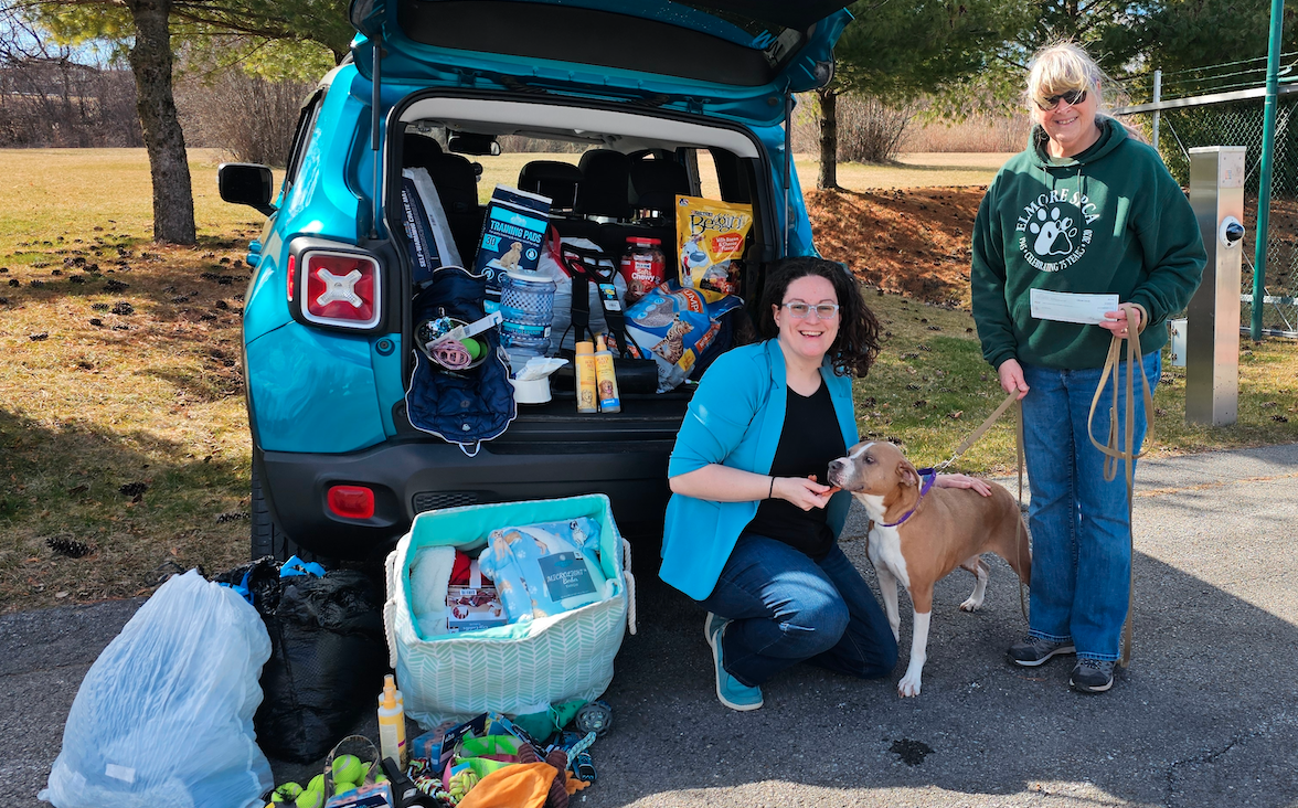 Volunteers from SPCA with donated supplies and dog