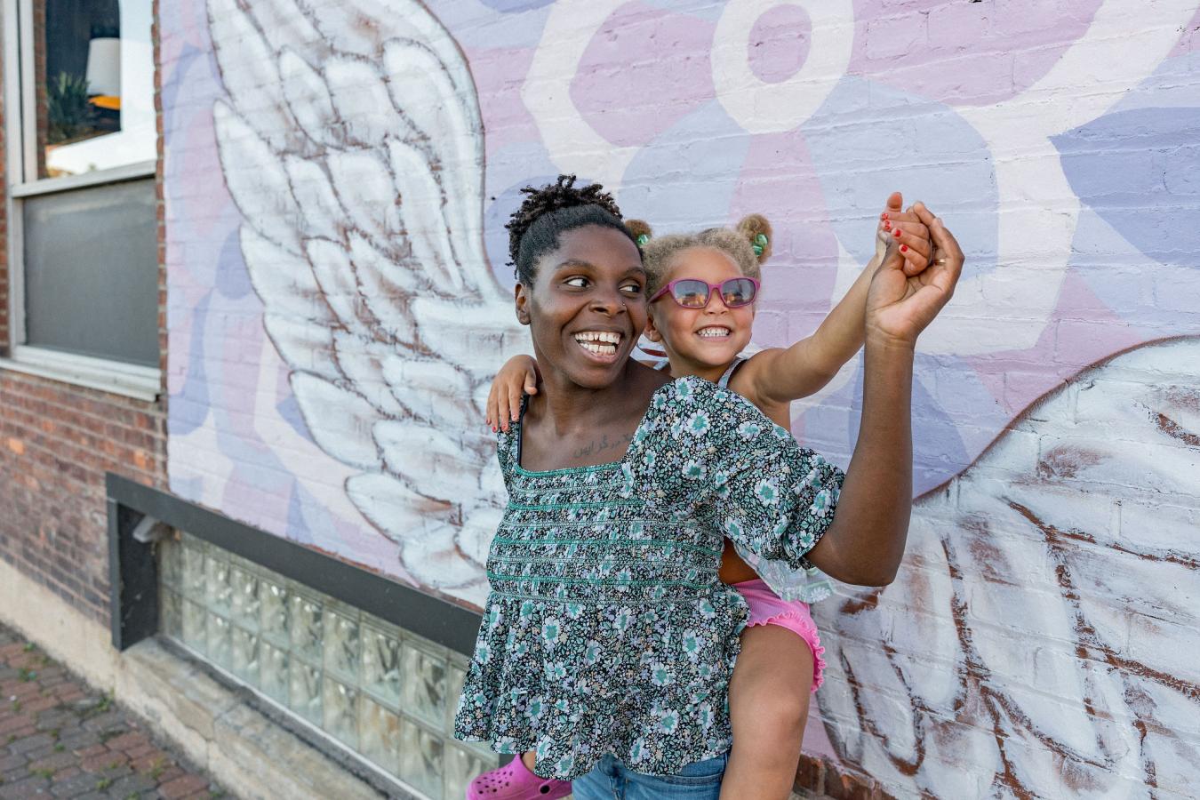 Woman and child at wings mural Plattsburgh NY