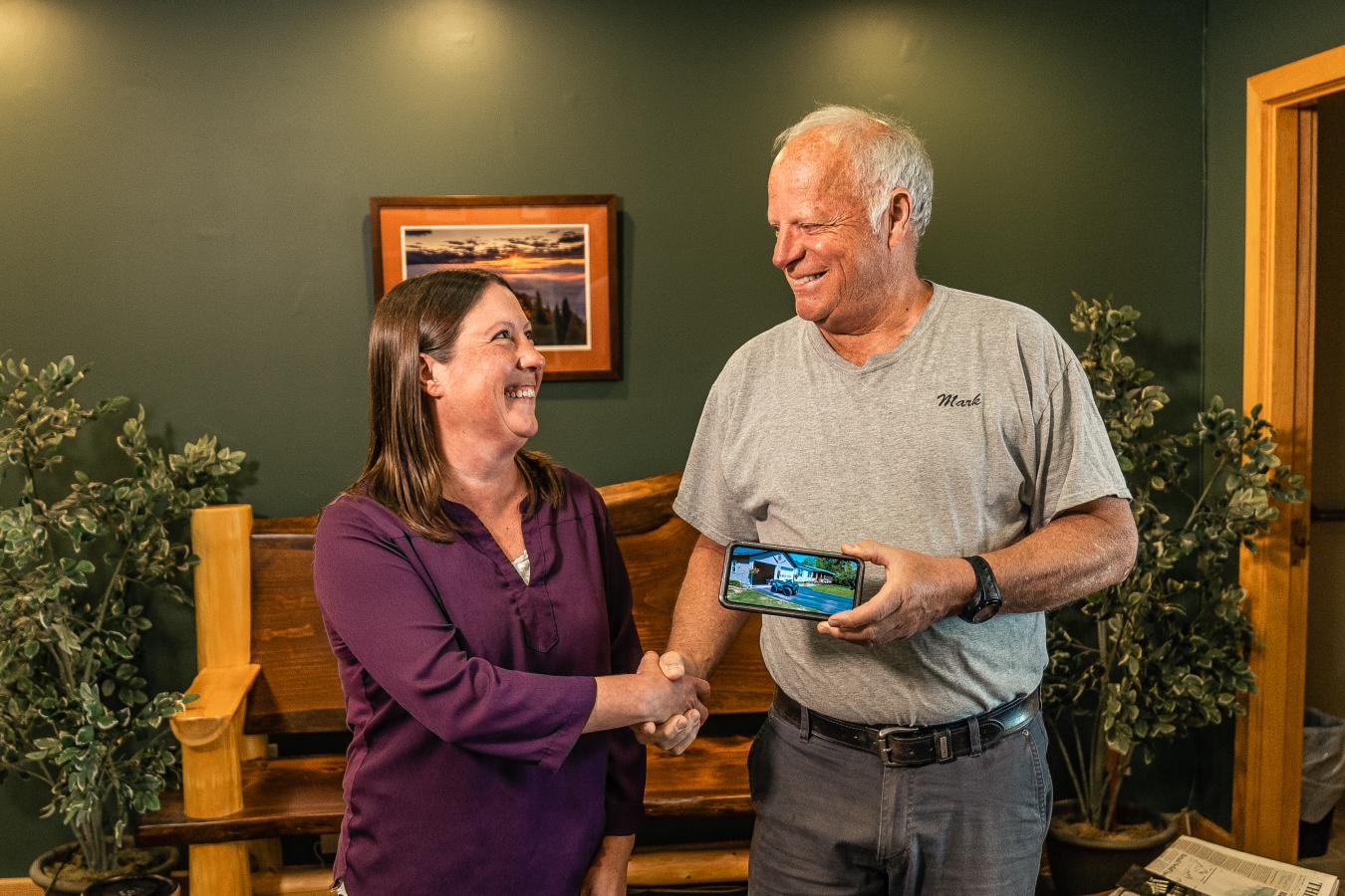 woman and man happily shaking hands.