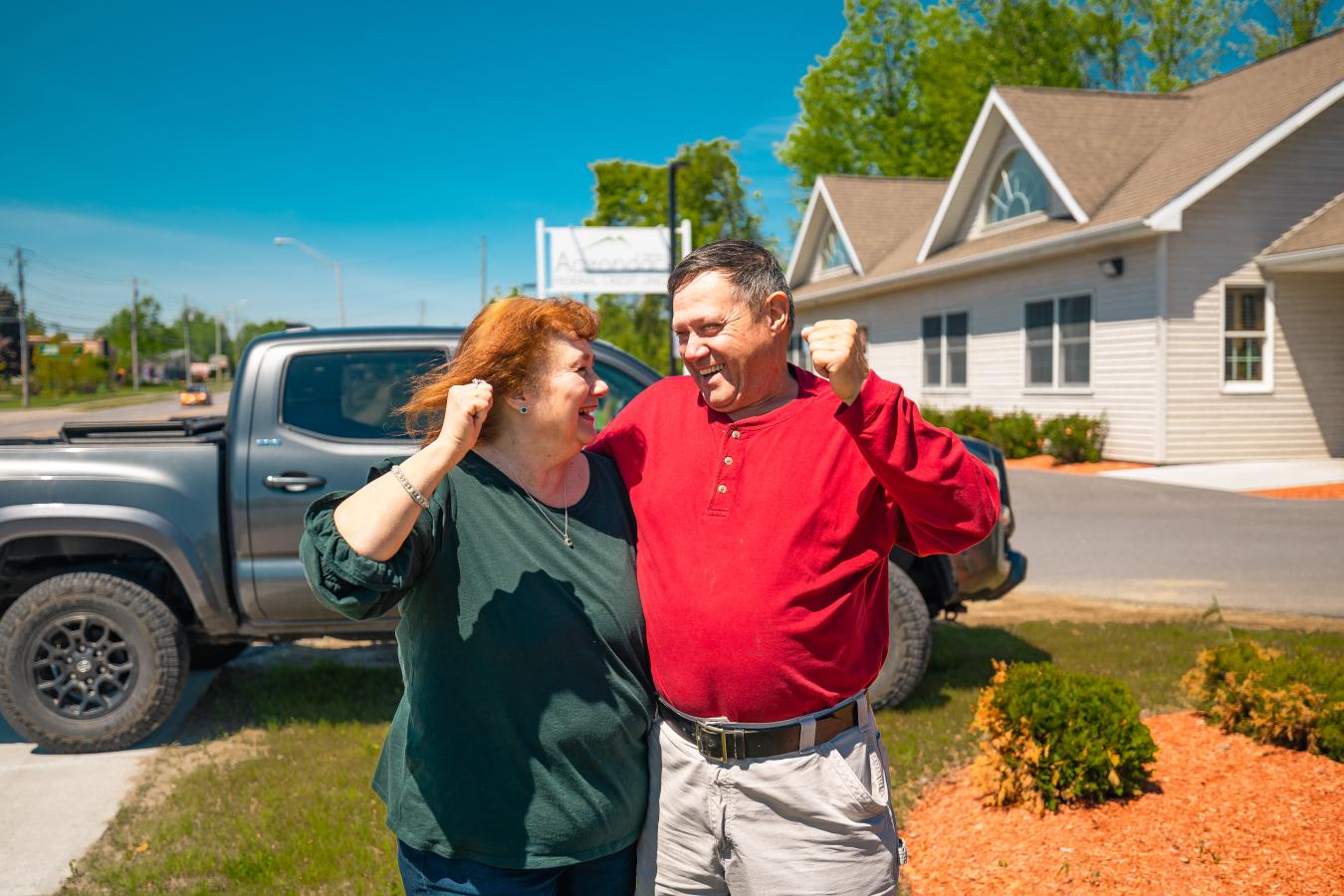 woman and man cheering outside