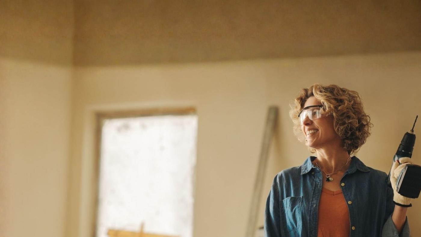 happy woman working on home improvements