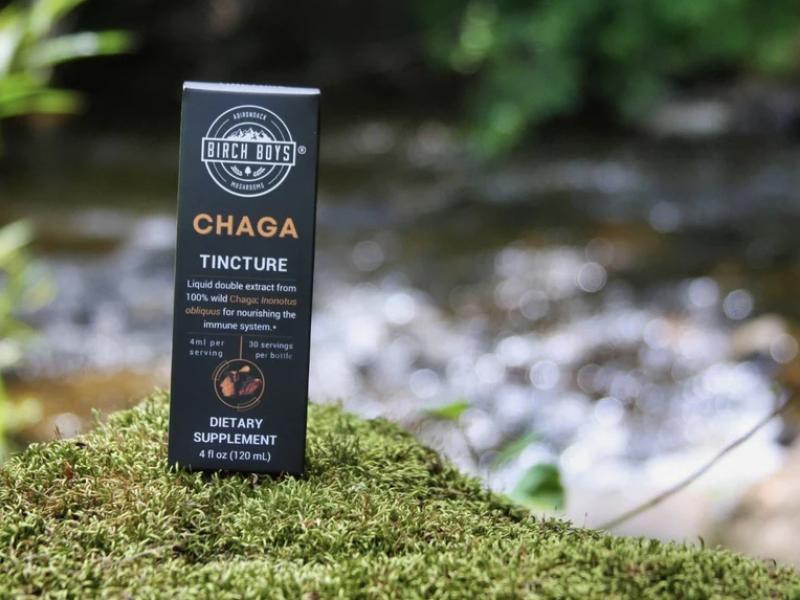Birch Boys chaga tincture packaging with a river in the background.