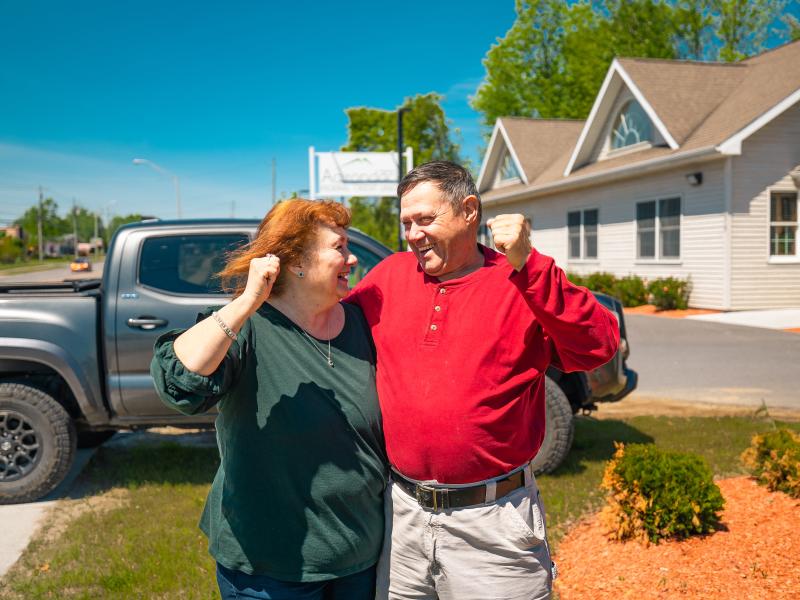 woman and man cheering outside