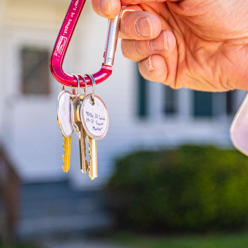 Person holding the keys to their new home after getting a mortgage with Adirondack Regional Federal Credit Union