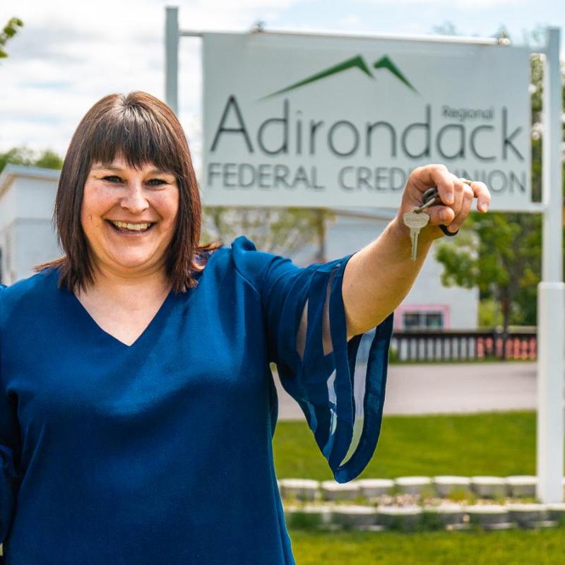 Adirondack Regional FCU Banker outside bank showing keys