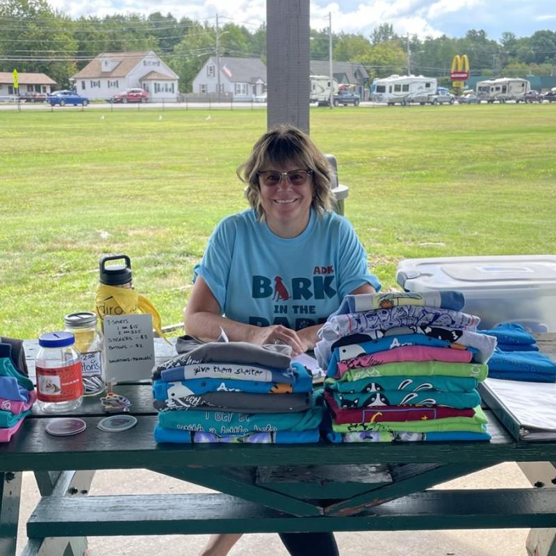 A member at a charity event handing out shirts