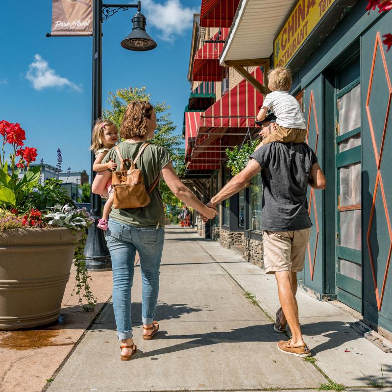 Family walking down street in Tupper Lake NY