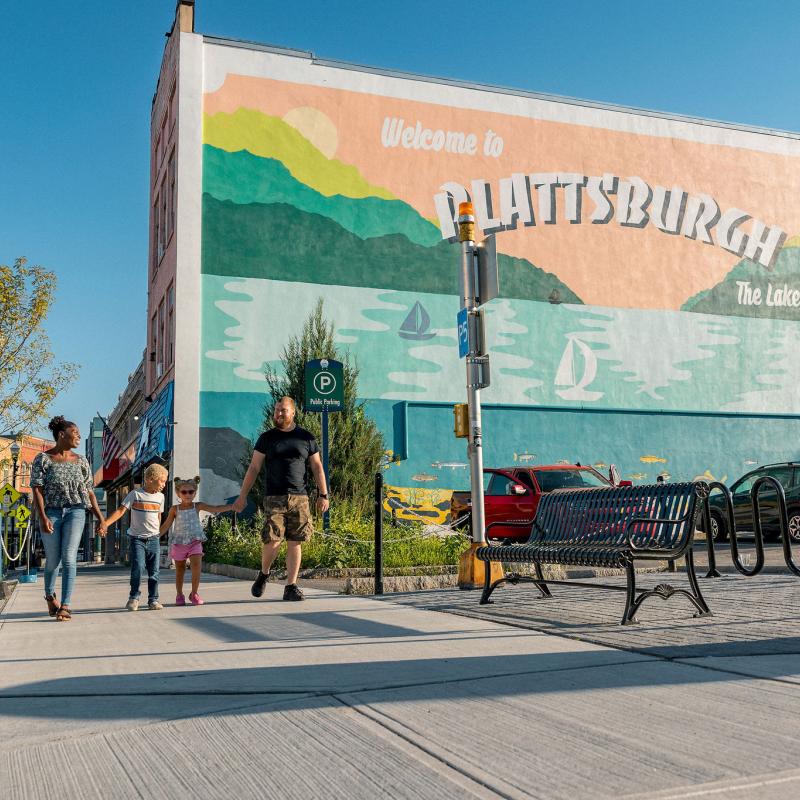 Downtown Plattsburgh mural with family walking on sidewalk