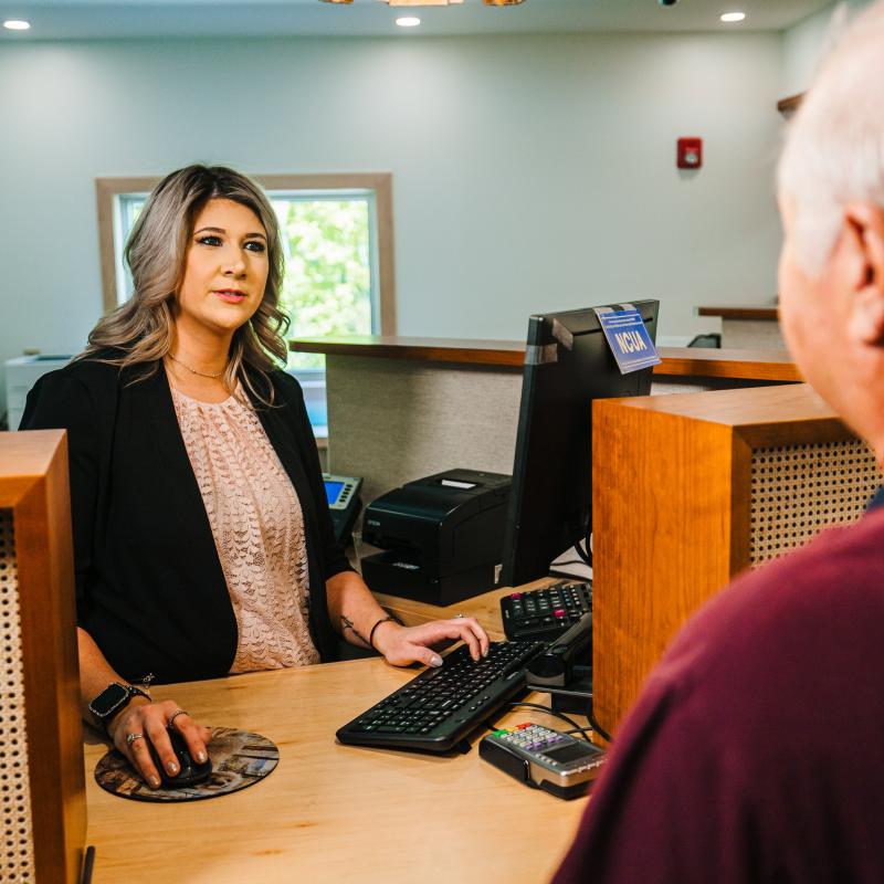 Credit union staff helping member