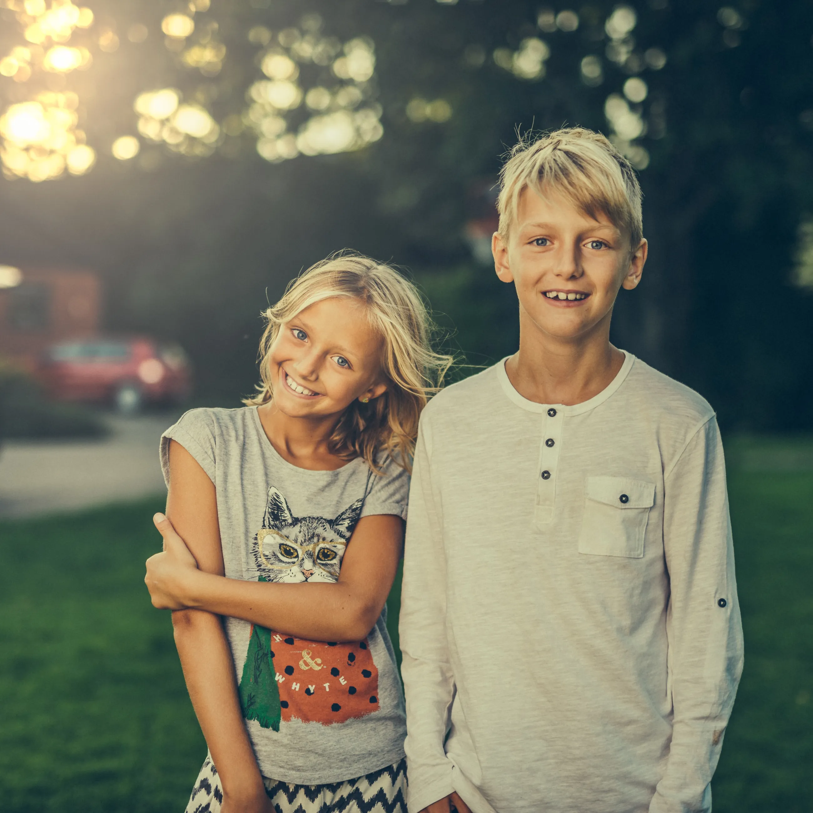 Pre-teen girl and boy facing camera.