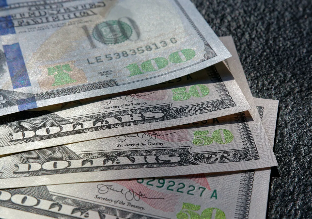 A fan of four US dollar bills. 